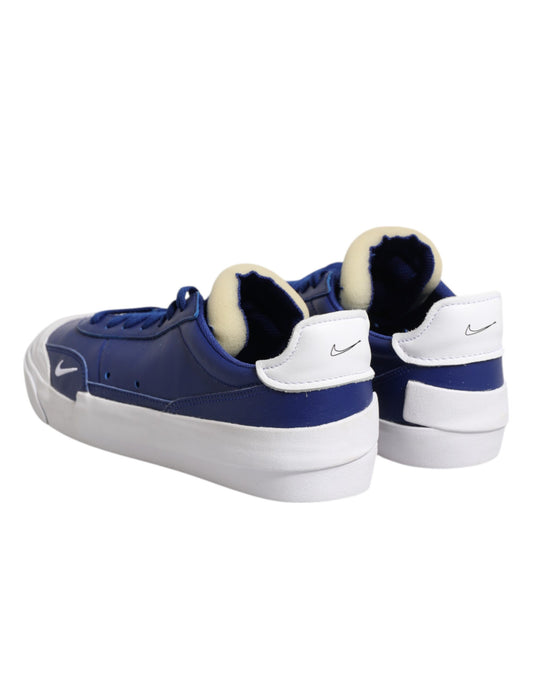 Blue sneakers with white soles and a white nike swoosh on each side