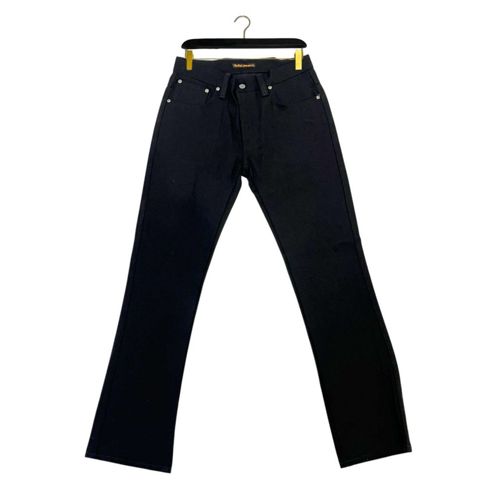 Pair of dark blue jeans on hanger
