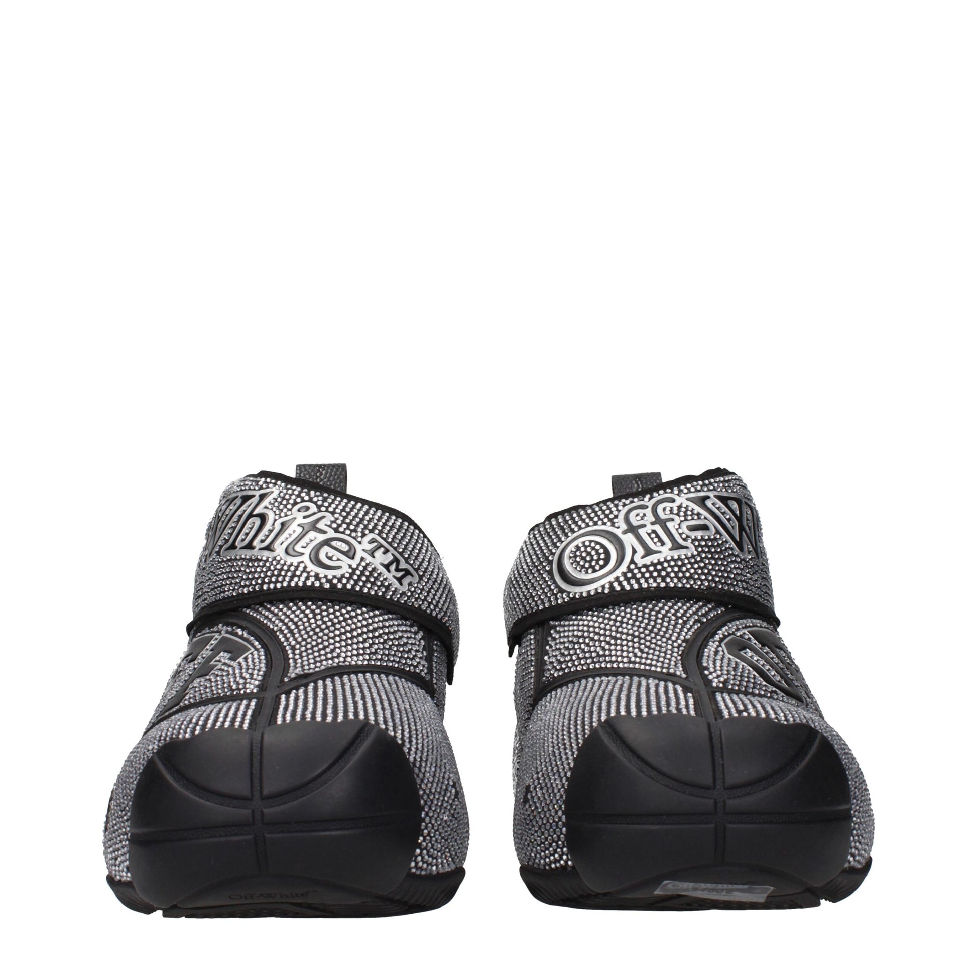 Pair of black and white sneakers with textured fabric, laces, and rubber soles