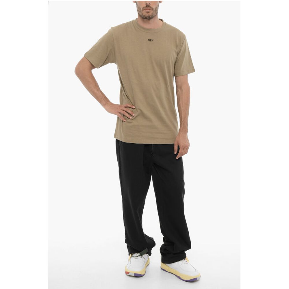 Man wearing olive green t-shirt and black pants