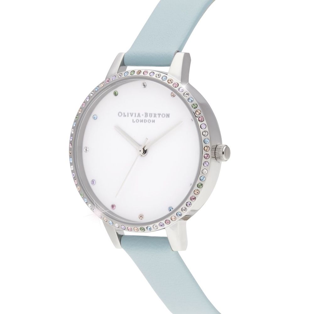 A blue artificial leather watch with a white face, sparkling crystals on the bezel and hands, and a silver buckle