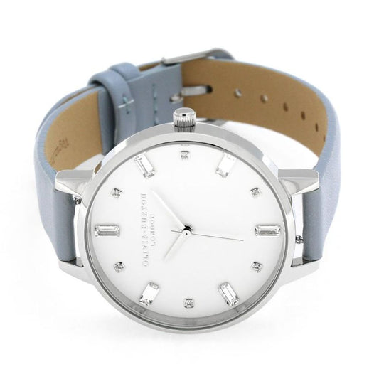 A blue leather watch with a white face, silver hands, and diamond accents