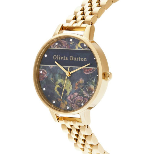 A gold stainless steel watch with a floral print face, featuring the name "Olivia Burton" and diamond hour markers