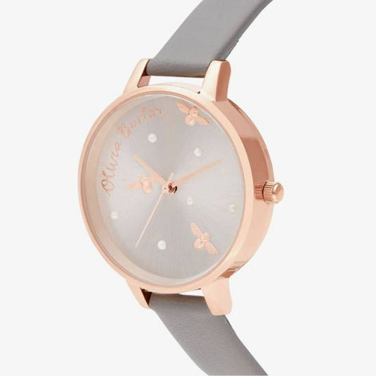 A gray artificial leather watch with a rose gold case, white face, and pink hands