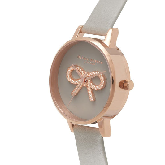 A gray artificial leather watch with a copper-colored band, featuring a bow design on the face and a silver buckle