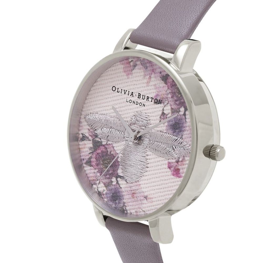 A gray artificial leather watch with a floral print face, featuring a butterfly design and the brand name "Olivia Burton Lond