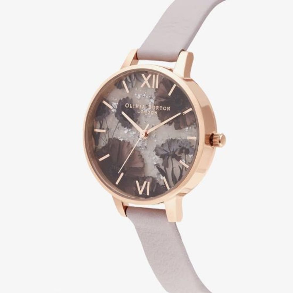 A multicolored watch with a floral pattern on the face, featuring a rose gold case and matching bracelet