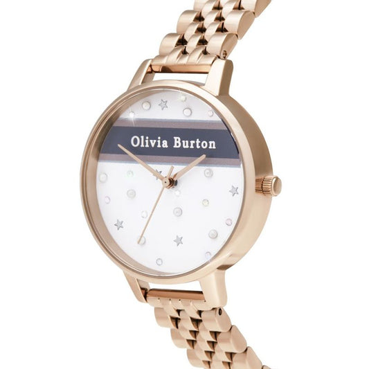 A gold tone watch with a white face featuring black text, sparkling stars and a name