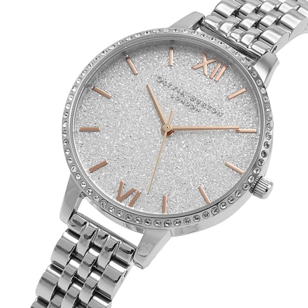 A silver stainless steel watch with a sparkly dial, featuring pink and gold accents