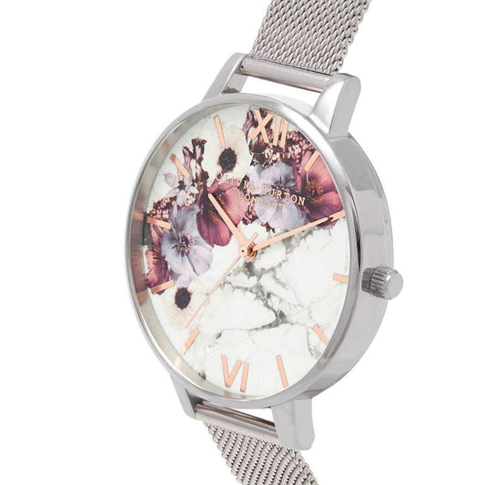A silver stainless steel watch with a floral patterned face, featuring pink and purple flowers on a white marble background