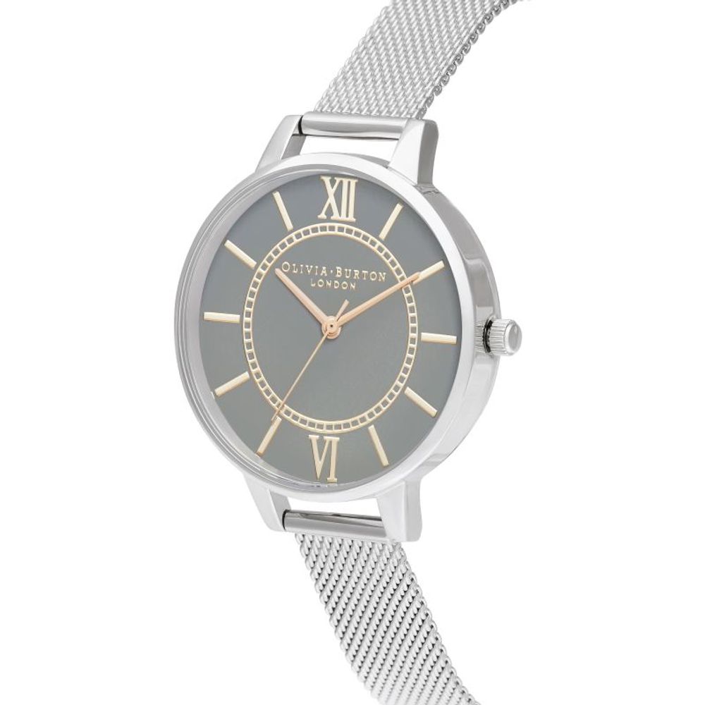 A silver stainless steel watch with a gold face, featuring Roman numerals and hands