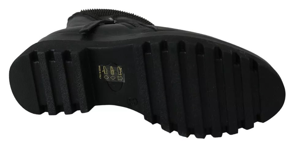 Black rubber boot with a thick sole and laces