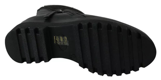 Black rubber boot with a thick sole and laces