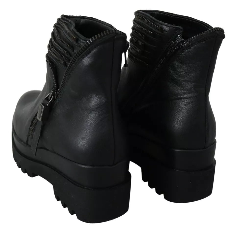 Pair of black leather boots with laces and a zipper on top
