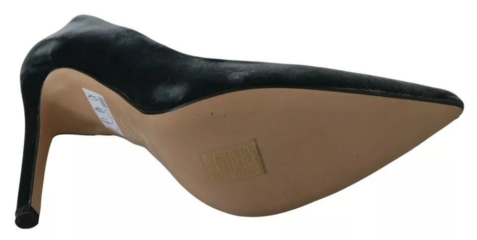 A pair of black velvet stiletto pumps with a tan heel and toe