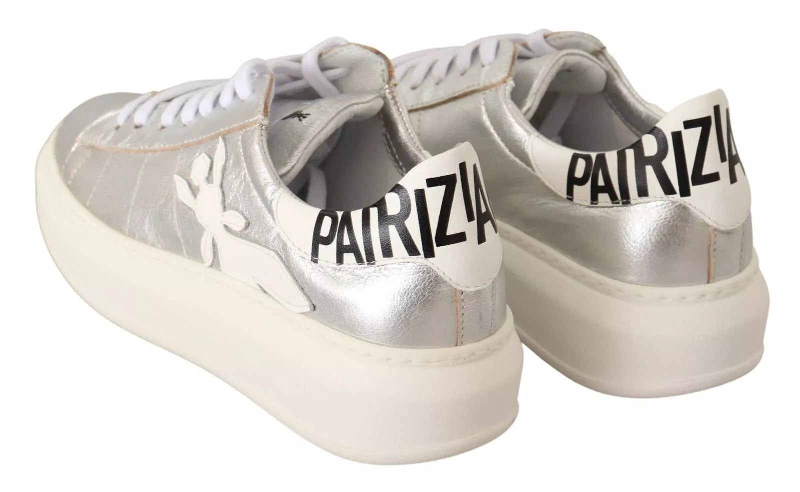 Silver sneakers with white laces and a black logo on the side
