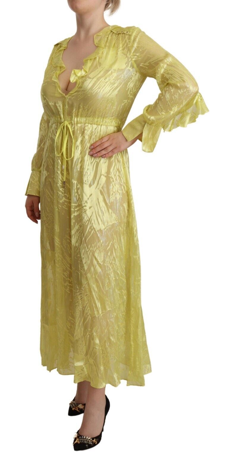 A long yellow silk dress with lace detailing and a plunging neckline