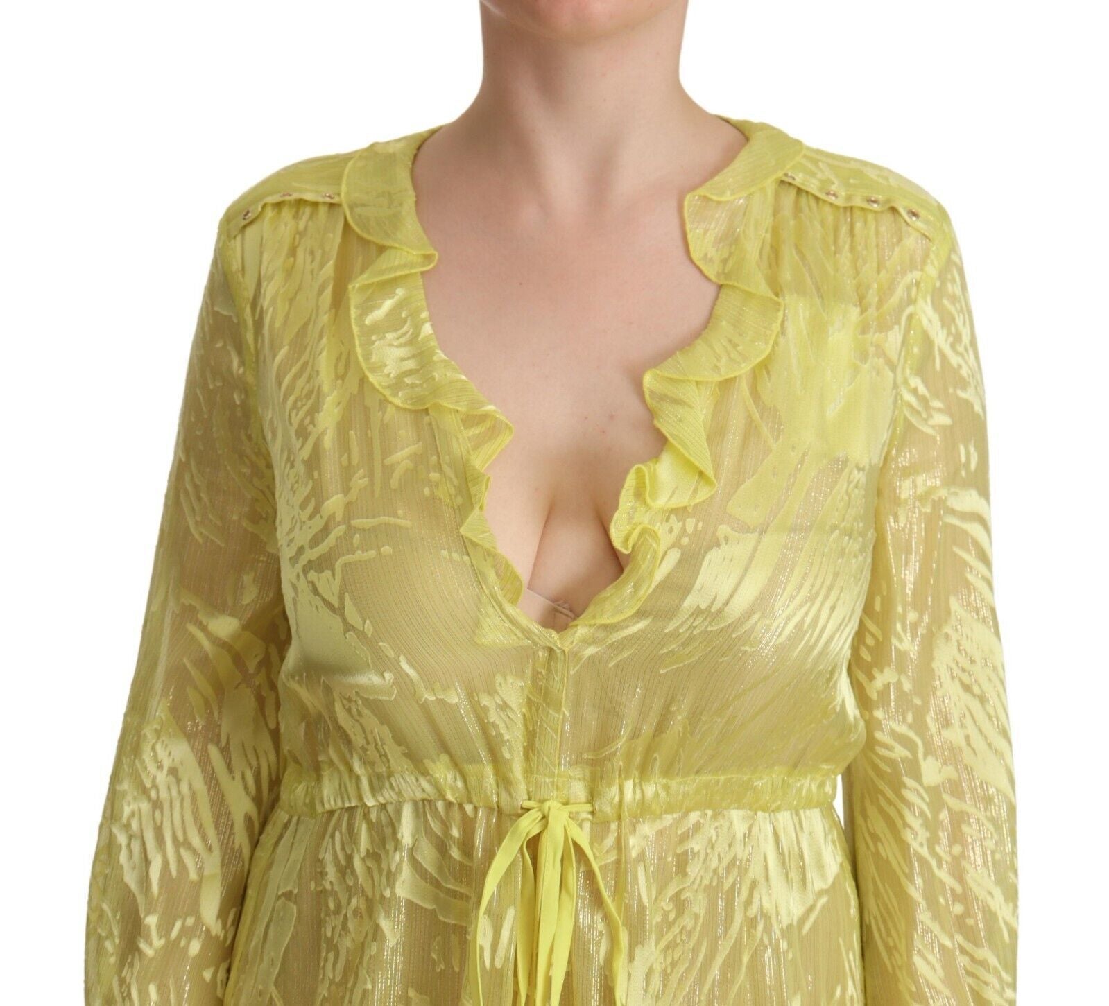 A yellow silk long sleeve dress with plunging neckline and ruffled details