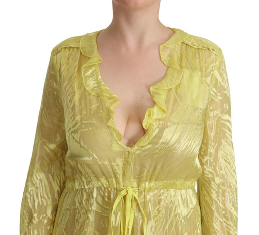 A yellow silk long sleeve dress with plunging neckline and ruffled details