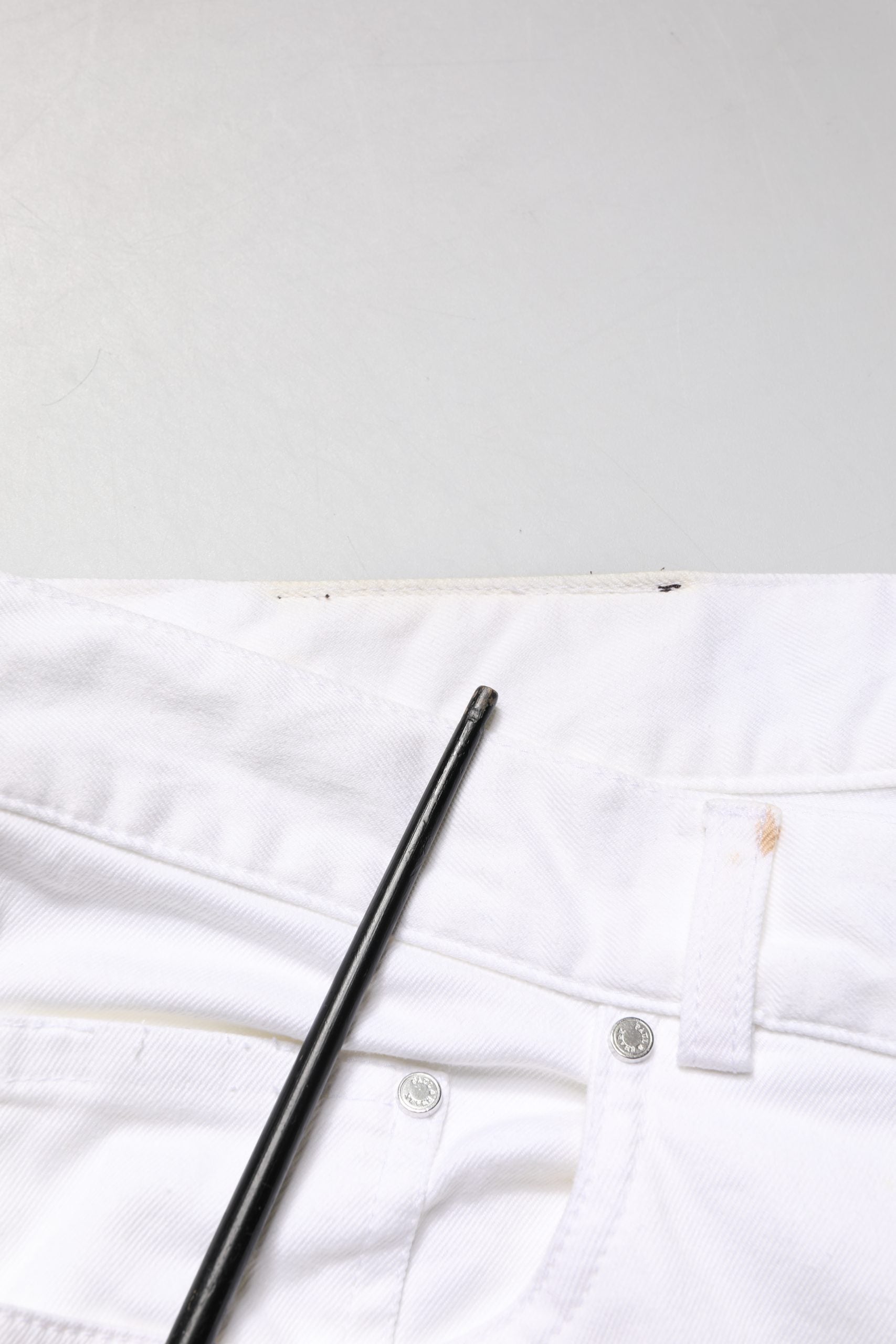 Pair of white jeans with black zipper