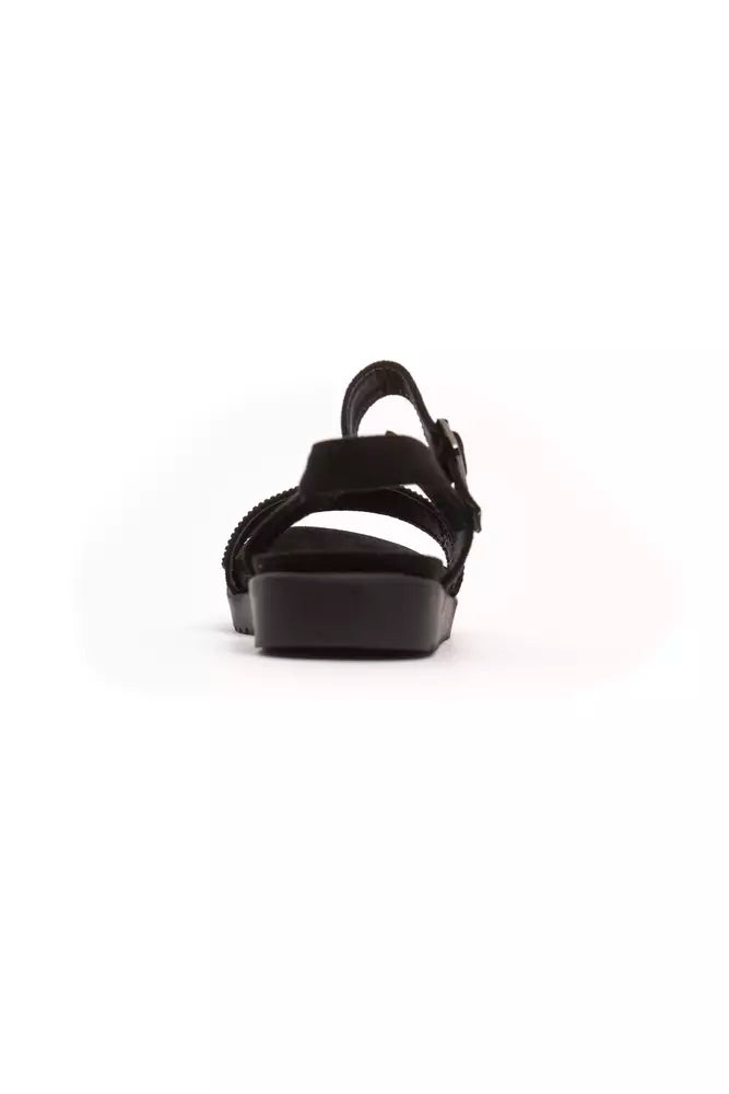 Black sandal with strap over foot and ankle