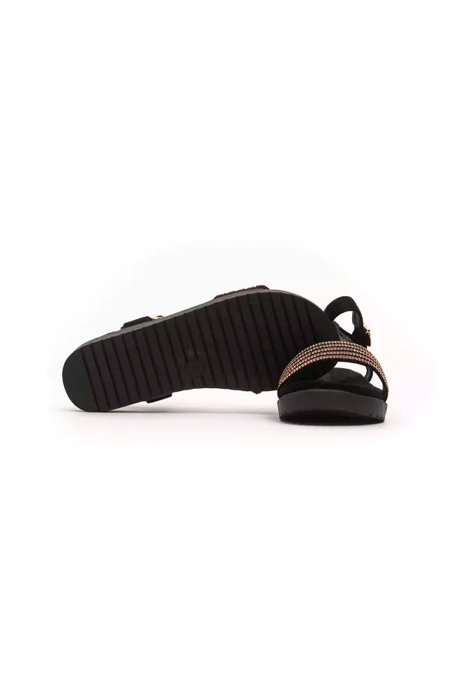 Pair of black flip flops with a strap over the foot and ankle