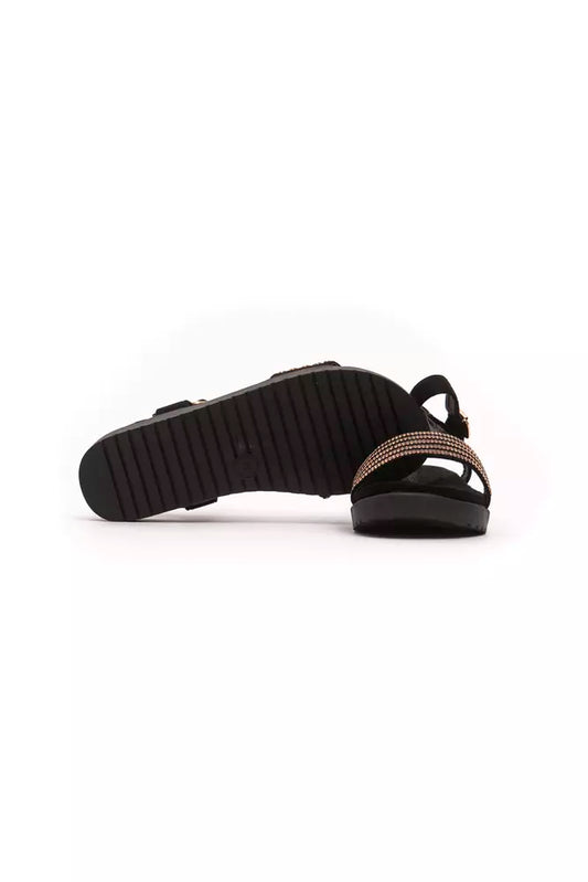 Pair of black flip flops with a strap over the foot and ankle