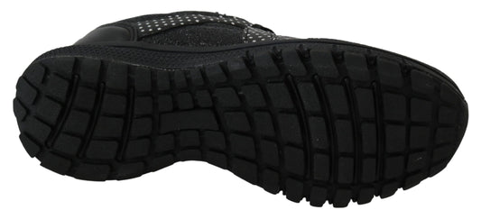 Pair of black hiking boots with deep treads and laces
