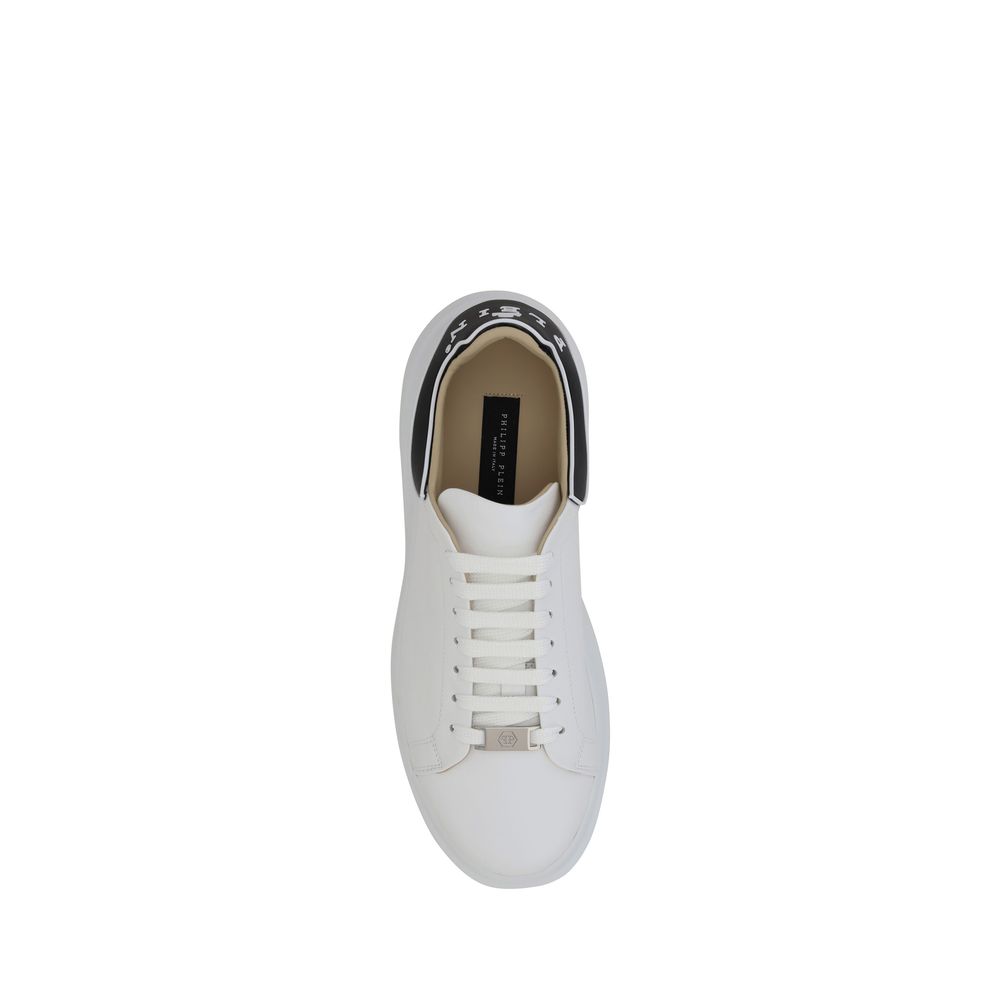A pair of white sneakers with black laces, featuring a low top and calf leather material