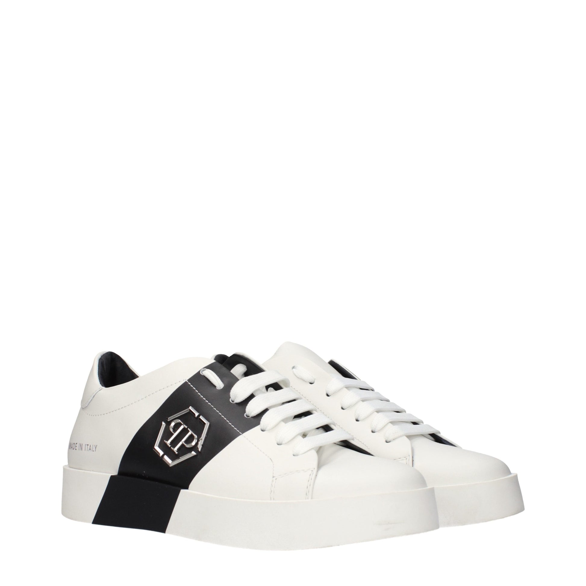 White leather sneakers with black laces and a black logo on the side