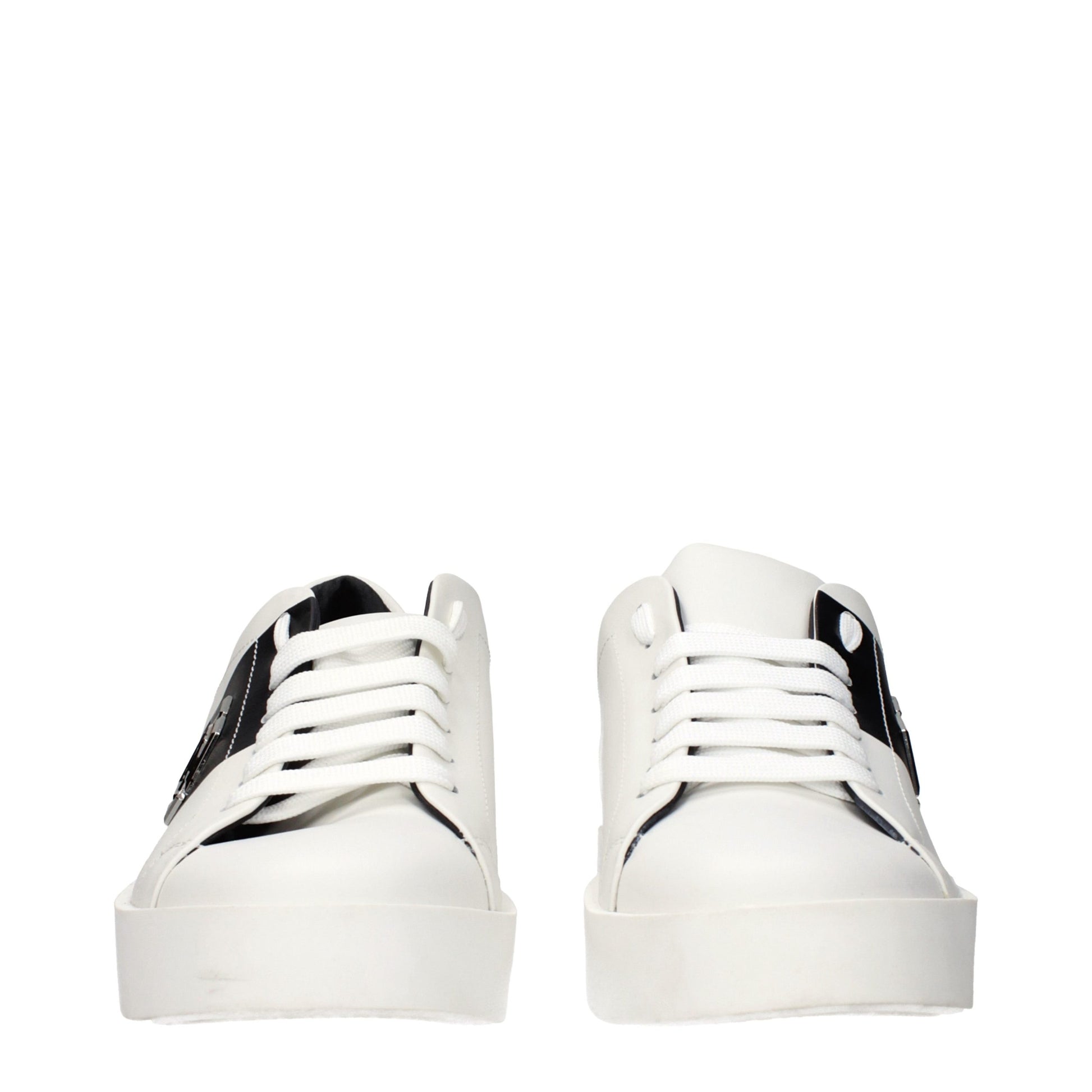 Pair of white leather sneakers with black laces, featuring a chunky sole design