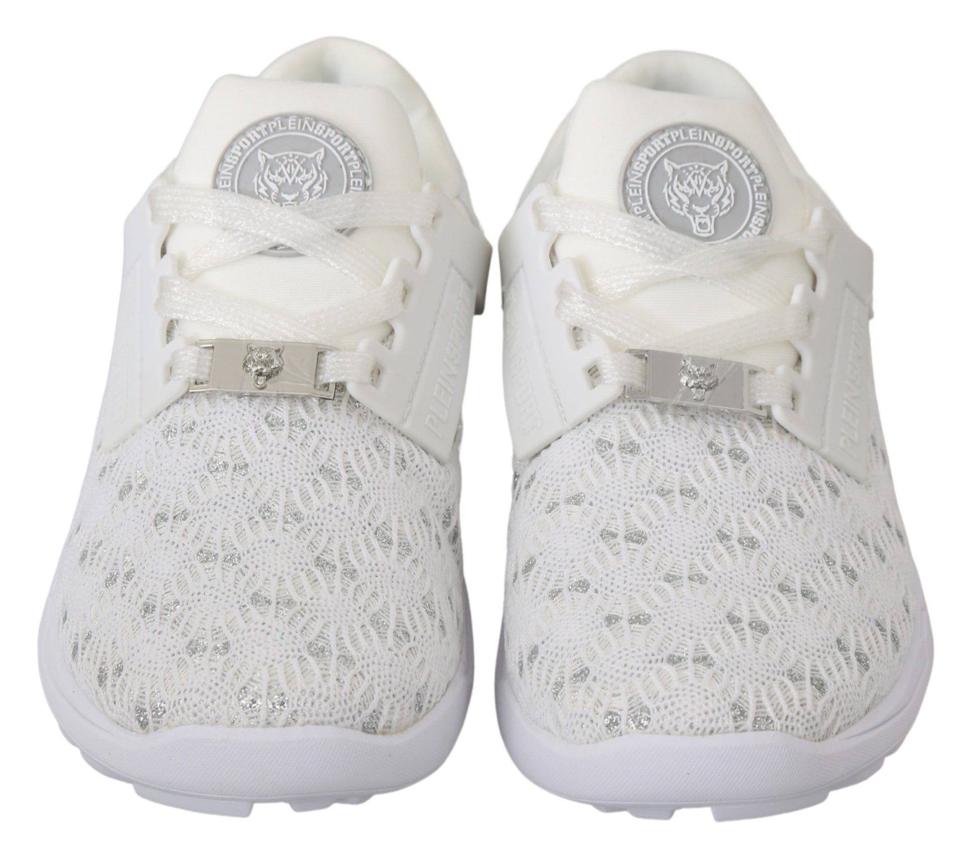 Pair of white sneakers with laces tied and a logo on the tongue
