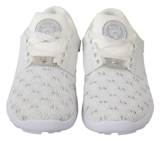 Pair of white sneakers with laces tied and a logo on the tongue