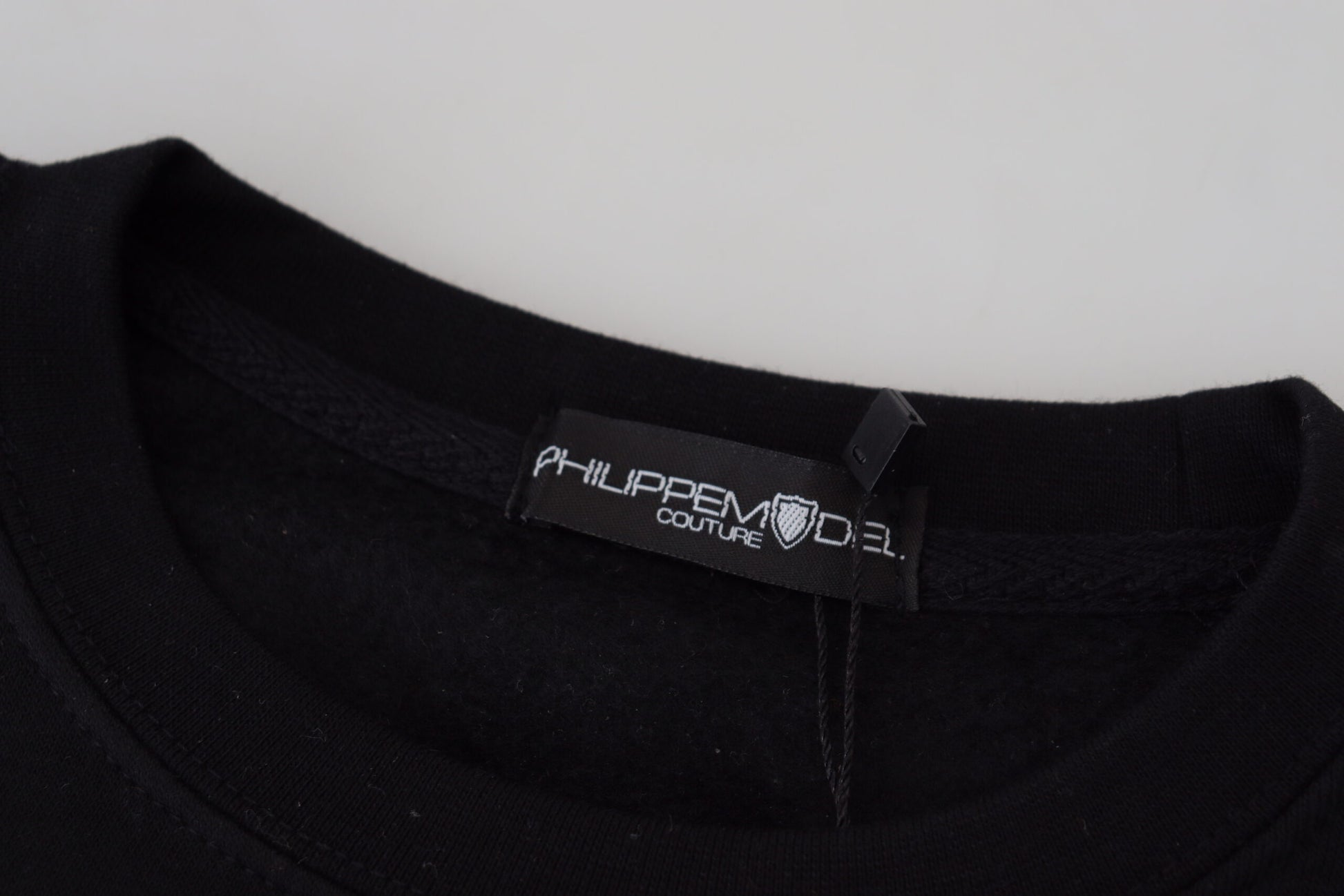 Black t-shirt on hanger with white label