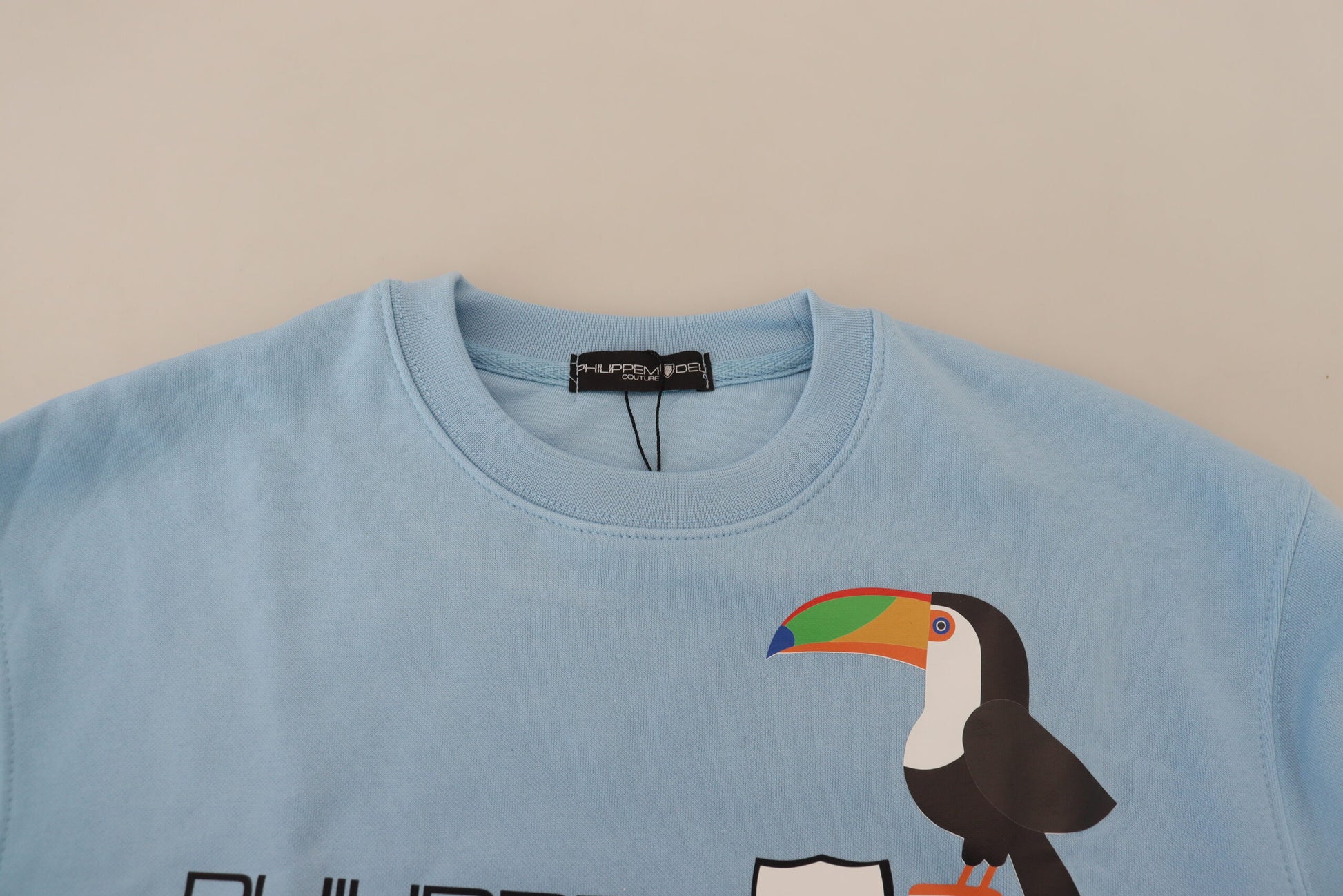 Blue sweater with parrot design on front