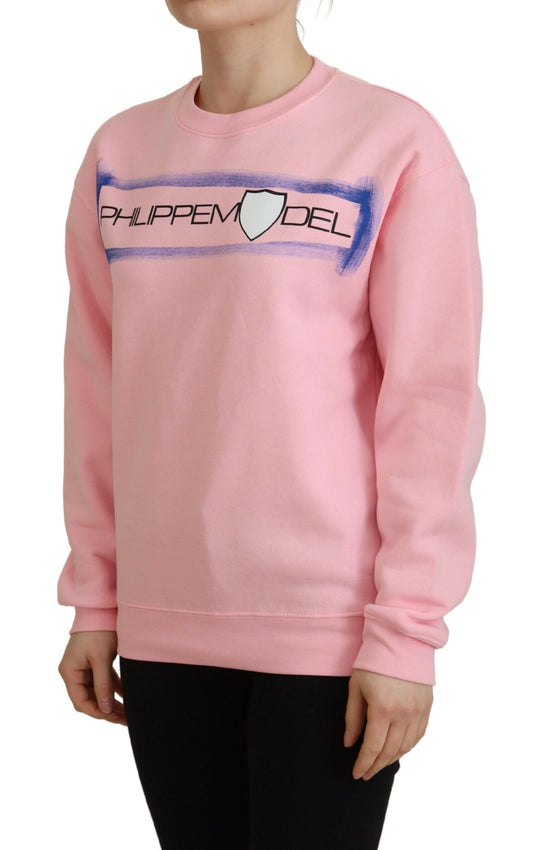 Pink sweatshirt with white lettering and graphic on front