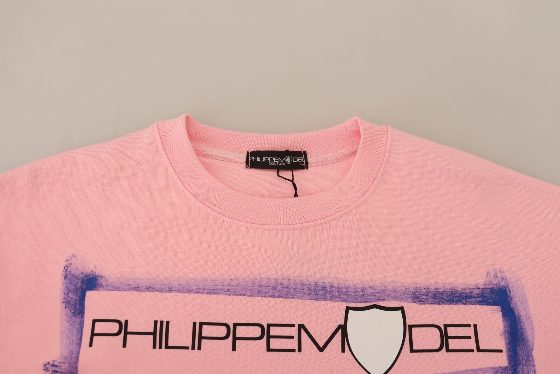 Pink sweater on hanger