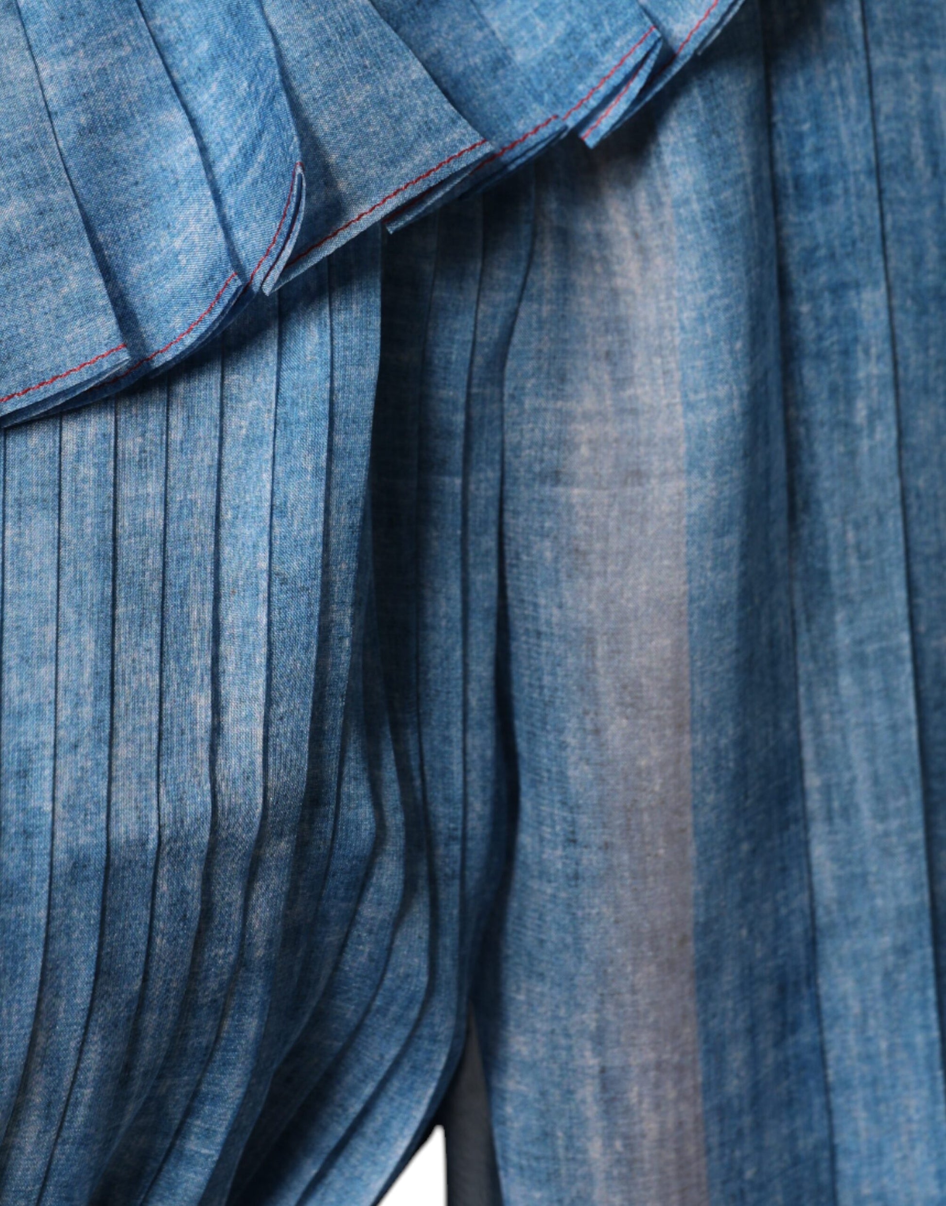 A blue denim layered long sleeve dress with ruffled hem and cuffs