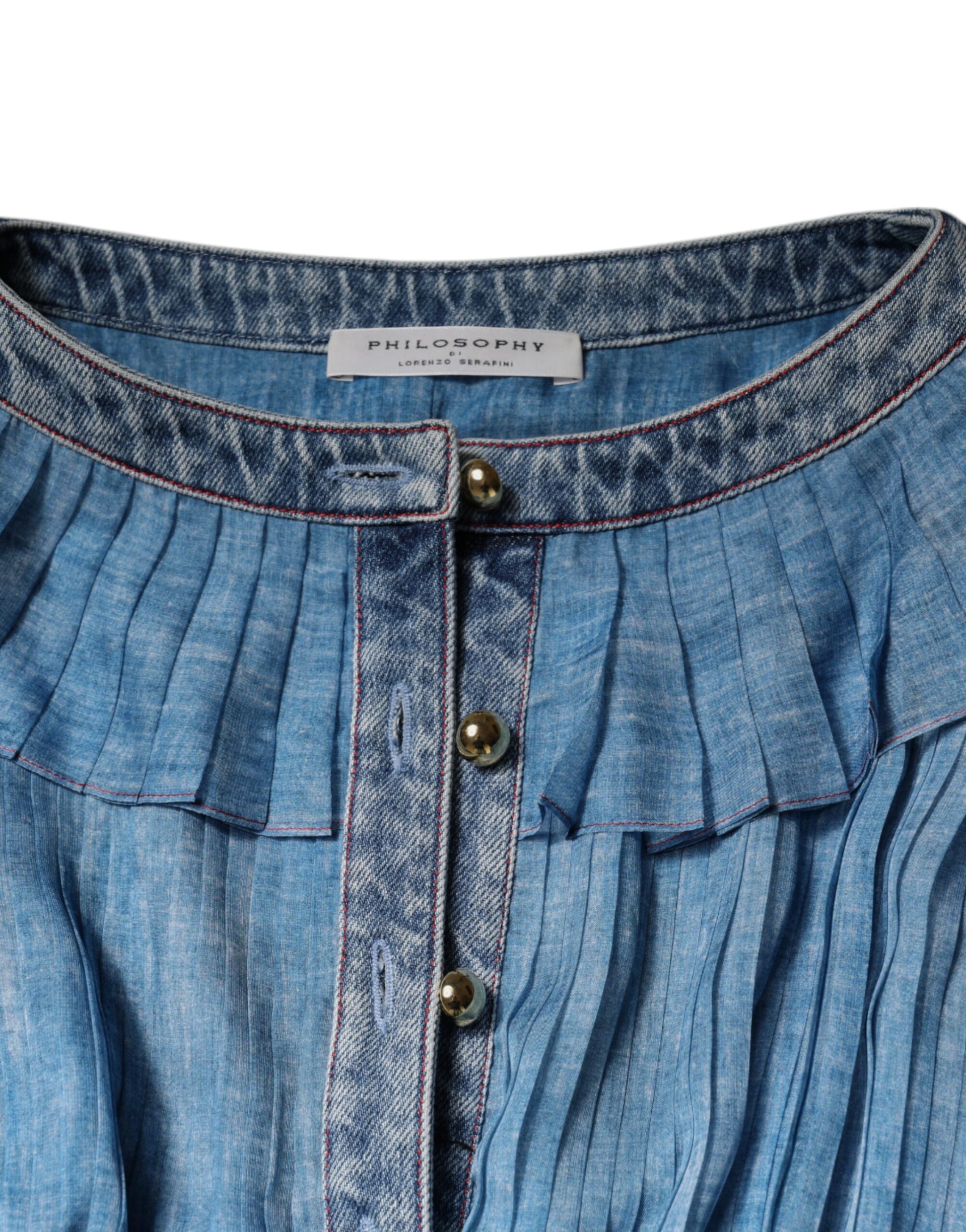 A blue denim dress with long sleeves, layered design, and ruffled hem