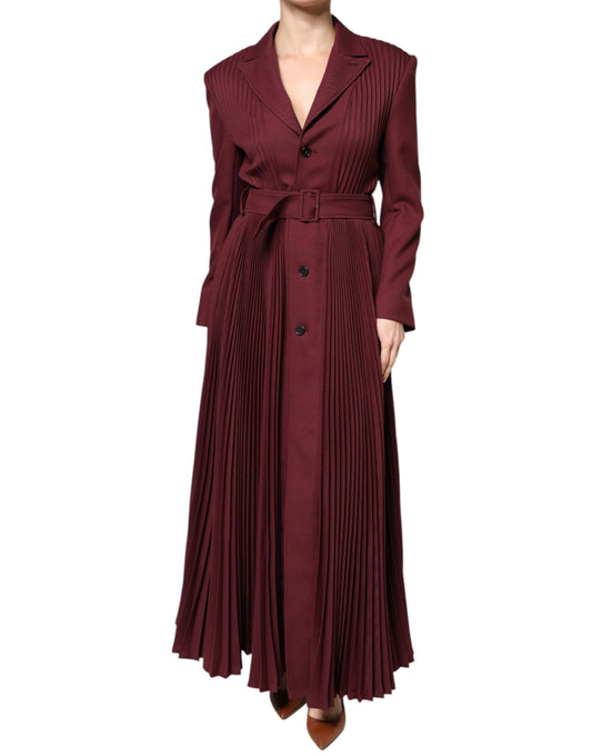 A maroon dress with belted waist, long sleeves and button down front. It has ruffled hem detailing