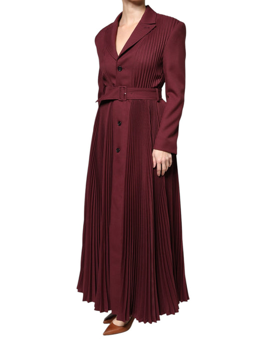 A long maroon dress with a belt at the waist, featuring horizontal ruffles and buttons down the front