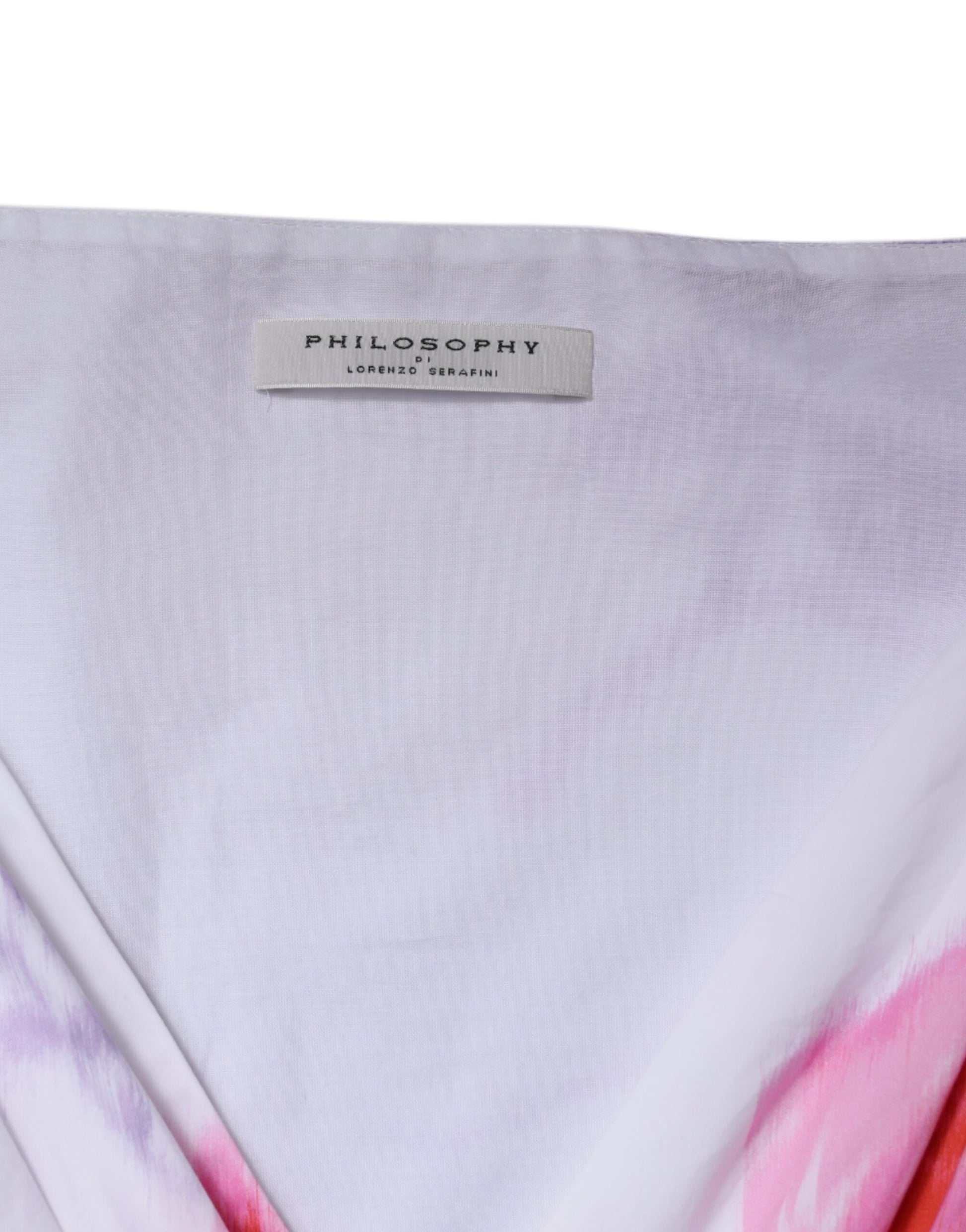 A white floral maxi dress with a label on the back