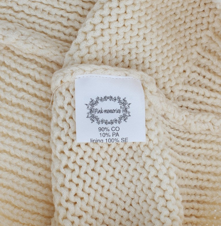 Tan knitted blanket with label indicating 90% cotton and 10% PA