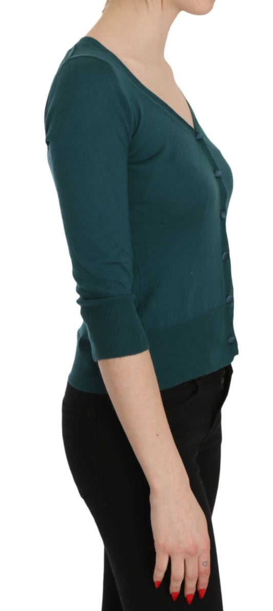 Woman wearing long sleeve green shirt and black pants