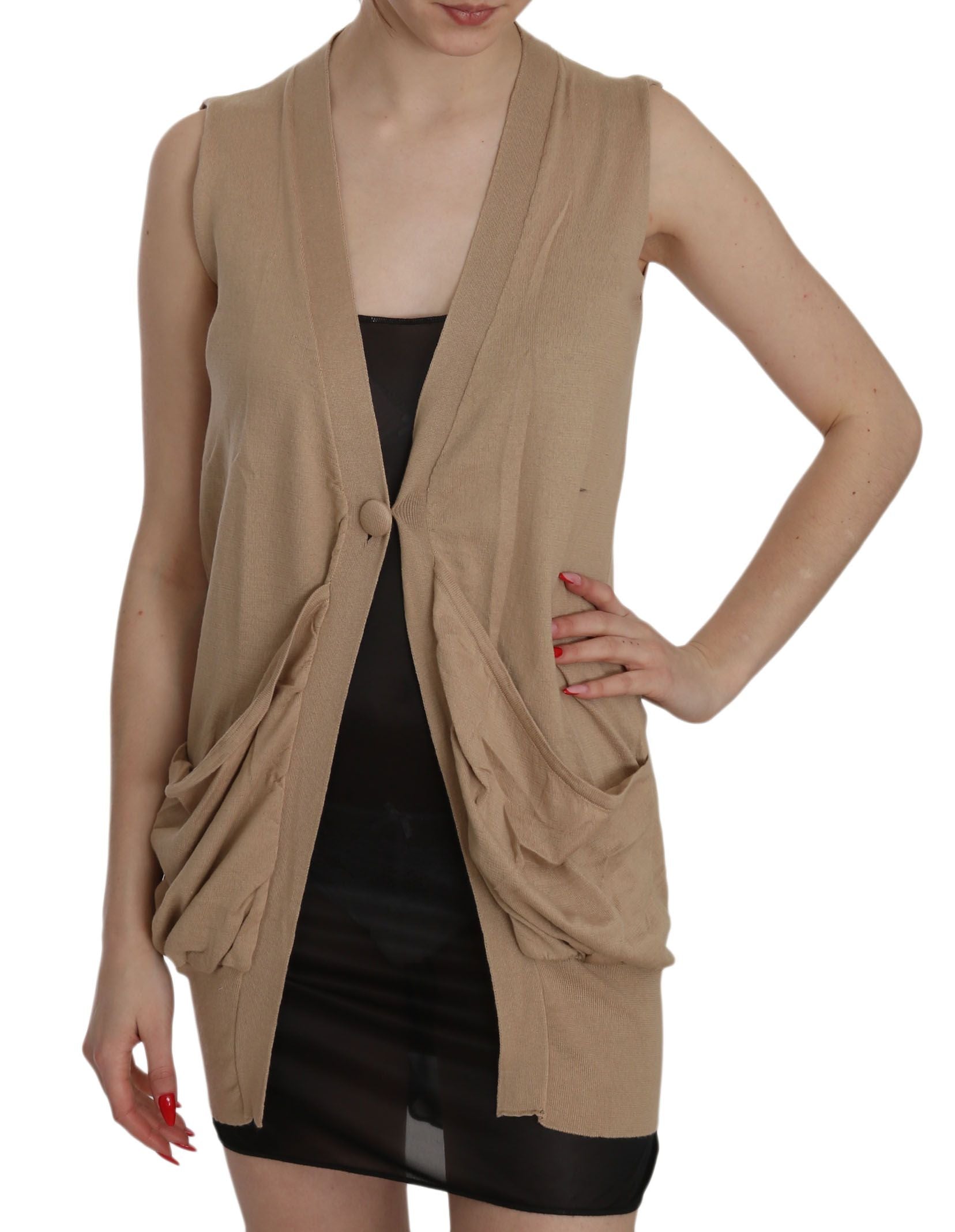 Woman wearing a beige vest over black dress
