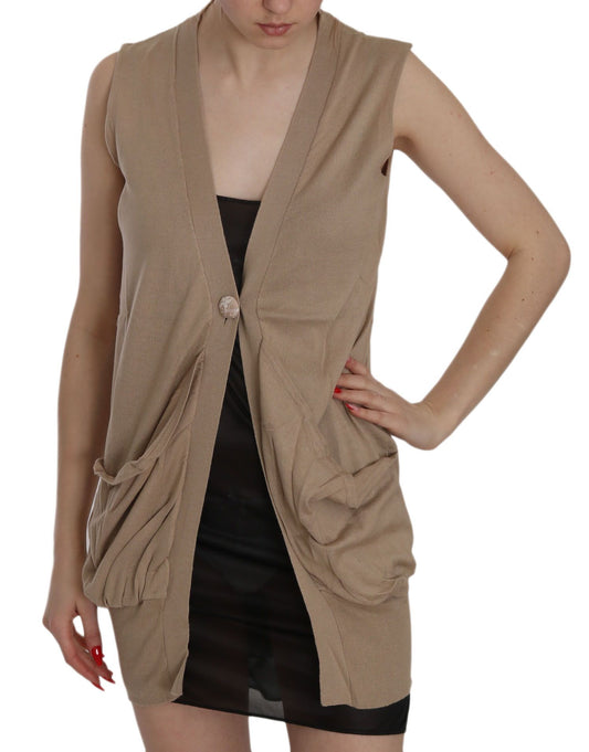 Woman wearing a beige vest over black dress