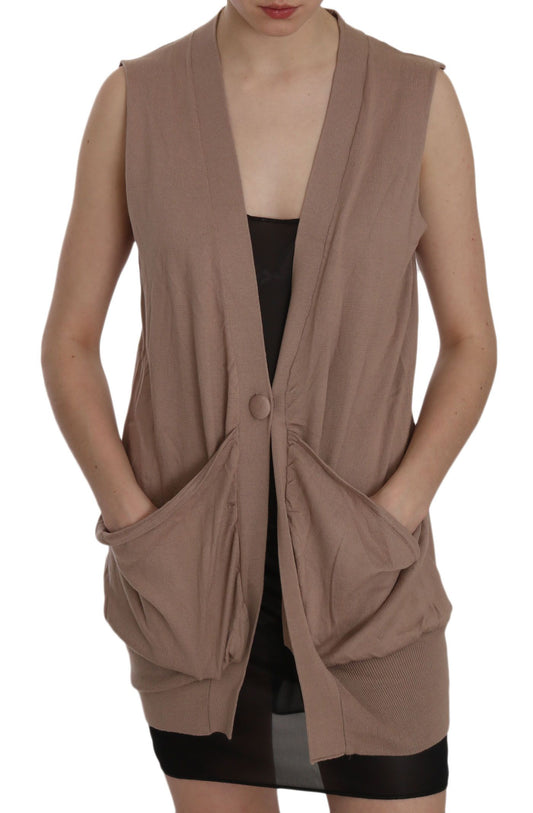 Woman wearing a beige vest over black dress