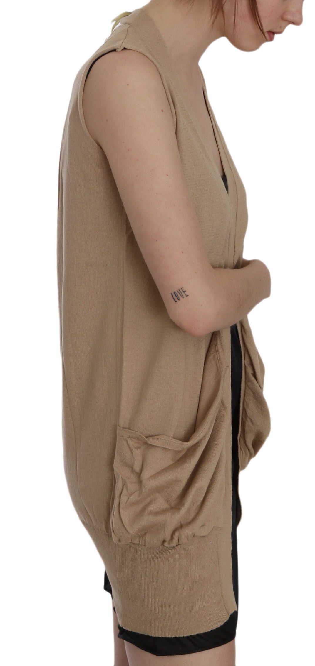 Woman wearing a beige dress with black straps