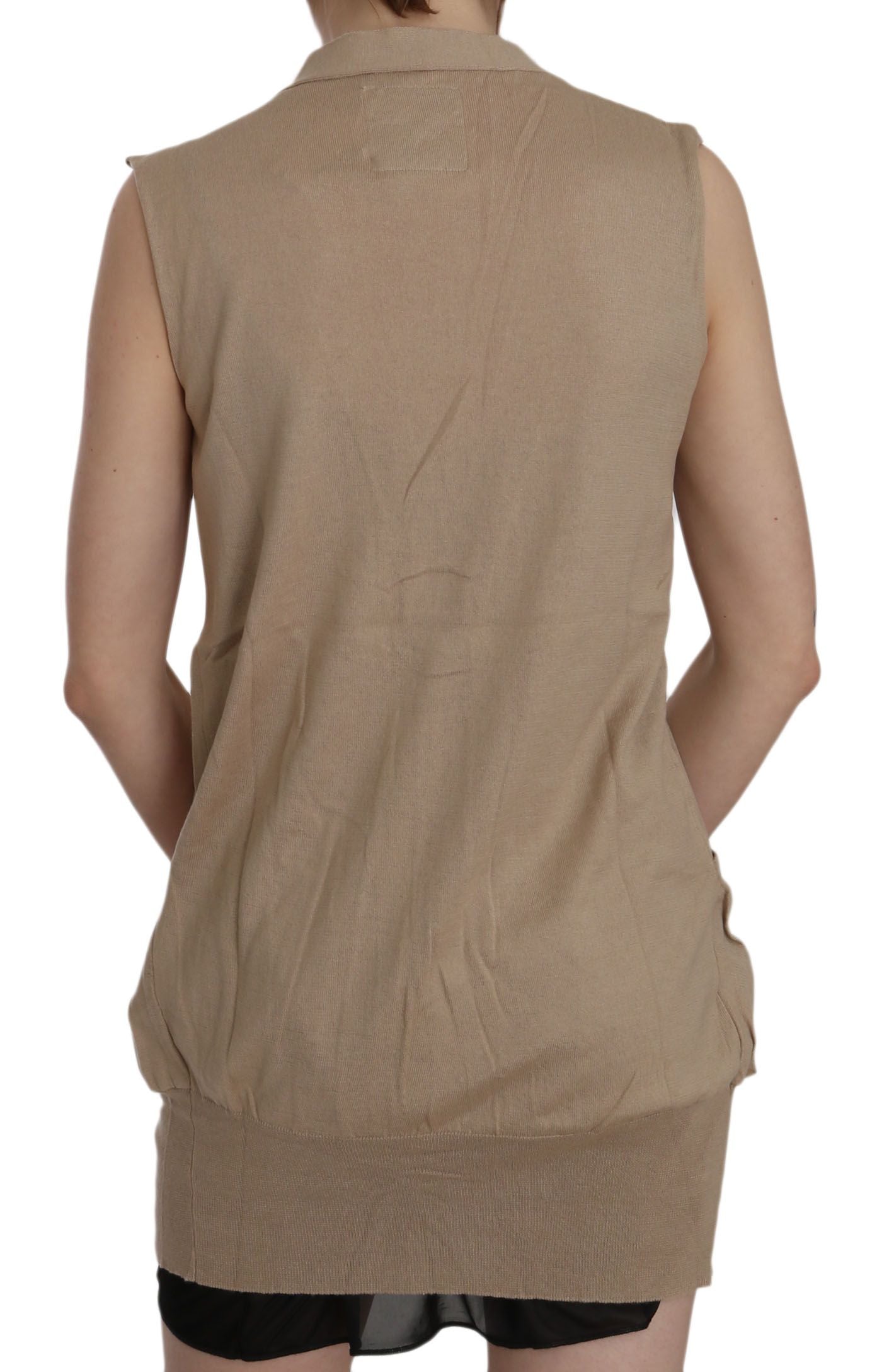 Tan sleeveless vest over black dress