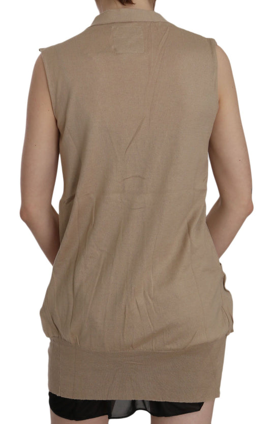 Tan sleeveless vest over black dress